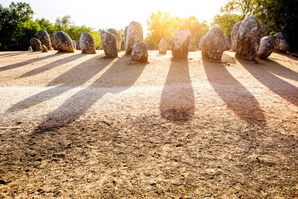 Sunrise view on the menhirs stones in megalithic monument of Cromelech dos Almendres in Portugal